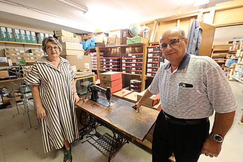 Union Shoe Store owners Angela and Bob Pappas stand beside a Singer leather sewing machine that's more than 100 years old last Thursday. It was once used by Alex Mehos at The Shoe Repair Store. (Abiola Odutola/The Brandon Sun)