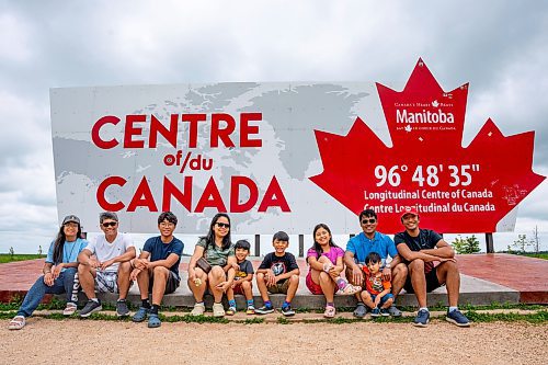 NIC ADAM / FREE PRESS
Alun Mallari (second from left) and his son Alec (right) from New Jersey USA pictured alongside their family from Winnipeg at the longitudinal centre of Canada, just off hwy 1 Tuesday.
240723 - Tuesday, July 23, 2024.

Reporter: Jura