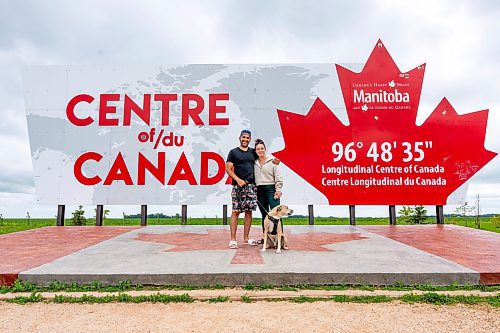 NIC ADAM / FREE PRESS
Simon Ferreira, Sara Mihaly, and Arlo (from left) from Hamilton Ontario pictured at the longitudinal centre of Canada, just off hwy 1 Tuesday.
240723 - Tuesday, July 23, 2024.

Reporter: Jura