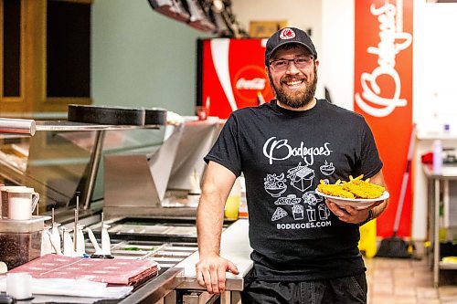 MIKAELA MACKENZIE / FREE PRESS

Andrew Van Seggelen, co-owner of Bodegoes, with a plate of their chicken fingers on Tuesday, July 23, 2024. 

For Dave Sanderson story.