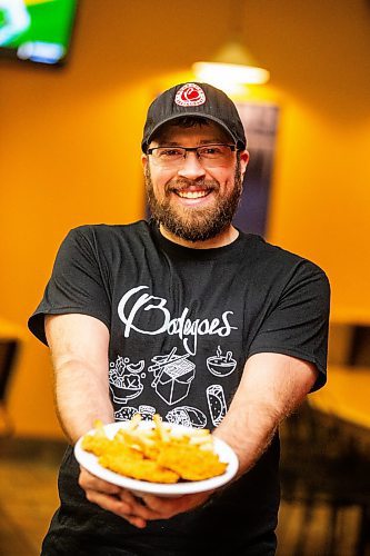 MIKAELA MACKENZIE / FREE PRESS

Andrew Van Seggelen, co-owner of Bodegoes, with a plate of their chicken fingers on Tuesday, July 23, 2024. 

For Dave Sanderson story.