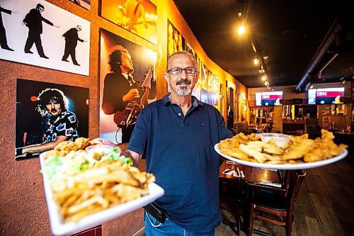 MIKAELA MACKENZIE / FREE PRESS

Owner Johnny Giannakis holds plates of chicken fingers at Johnny G's on Tuesday, July 23, 2024. 

For Dave Sanderson story.