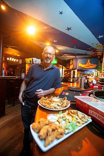 MIKAELA MACKENZIE / FREE PRESS

Owner Johnny Giannakis with plates of chicken fingers at Johnny G's on Tuesday, July 23, 2024. 

For Dave Sanderson story.