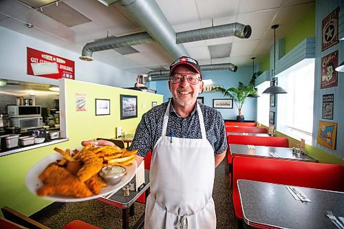 MIKAELA MACKENZIE / FREE PRESS

Owner Bruce Smedts with a plate of chicken fingers a the White Star Diner on Tuesday, July 23, 2024. 

For Dave Sanderson story.