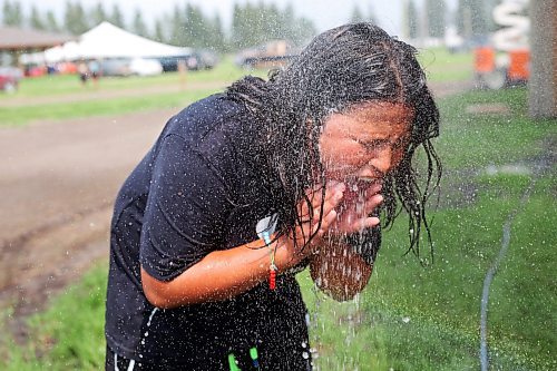 23072024
Dameek Noel cools off in the spray from a sprinkler during the first day of the inaugural Dakota FACTS Camp at Sioux Valley Dakota Nation on a hot Tuesday. The camp is aimed primarily at Dakota youth between the ages of 13-18 and consists of a variety of events, teachings, entertainment and sports around the themes of Food, Agriculture, Climate Change, Tradition and Synergies (FACTS). The camp runs until Thursday.  (Tim Smith/The Brandon Sun)
