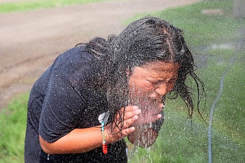 23072024
Dameek Noel cools off in the spray from a sprinkler during the first day of the inaugural Dakota FACTS Camp at Sioux Valley Dakota Nation on a hot Tuesday. The camp is aimed primarily at Dakota youth between the ages of 13-18 and consists of a variety of events, teachings, entertainment and sports around the themes of Food, Agriculture, Climate Change, Tradition and Synergies (FACTS). The camp runs until Thursday.  (Tim Smith/The Brandon Sun)
