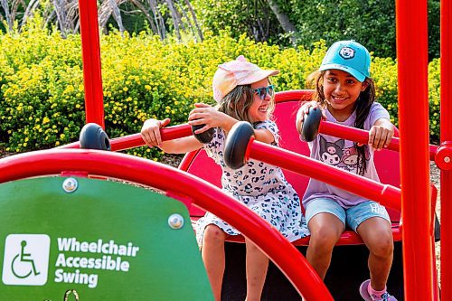 NIC ADAM / FREE PRESS
Friends from school, Paisley and Mia, play on the swings at the nature playground at Assiniboine park Tuesday afternoon.
240723 - Tuesday, July 23, 2024.

Reporter: ?