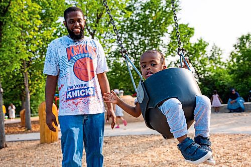 NIC ADAM / FREE PRESS
Kyle Grant and his two-year-old Bilal, from Georgia USA, play on the swings at the nature playground at Assiniboine park Tuesday afternoon.
240723 - Tuesday, July 23, 2024.

Reporter: ?