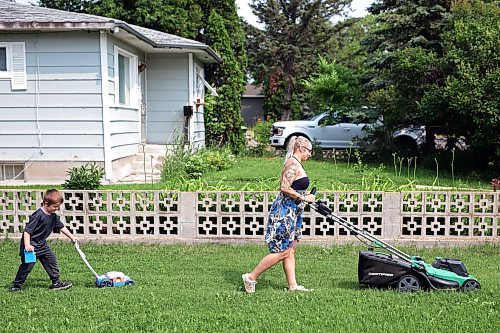 24072024
Five-year-old Owen Poitras follows along with his own toy lawnmower as his mom Marla Poitras mows the lawn at their home in Brandon on a hot Wednesday.
(Tim Smith/The Brandon Sun)