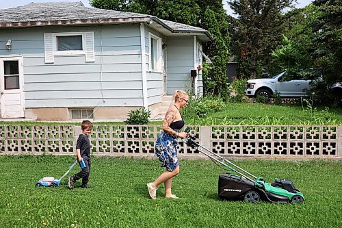 24072024
Five-year-old Owen Poitras follows along with his own toy lawnmower as his mom Marla Poitras mows the lawn at their home in Brandon on a hot Wednesday.
(Tim Smith/The Brandon Sun)