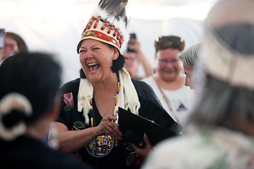 Wearing a ceremonial headress, Assembly of Manitoba Chiefs Grand Chief Cathy Merrick laughs while taking her oath of office following her first-ballot election victory for the position on Wednesday afternoon during the 36th Annual General Assembly that was held on Waywayseecappo First Nation land near Brandon. (Matt Goerzen/The Brandon Sun)