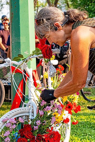 NIC ADAM / FREE PRESS
Hundreds of winnipeggers left flowers at the memorial  ghost bike honouring the life of cyclist Rob Jenner, who lost his life to a hit-and-run driver on Wellington Crescent at Cockburn Street, pictured Thursday afternoon.
240725 - Thursday, July 25, 2024.

Reporter: Jura