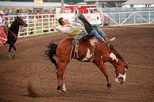 Colton Ouellette tries to stay atop his steed while competing in the bareback riding event at the first go-round of the 68th Annual Manitoba Threshermen’s Reunion and Stampede rodeo near Austin on Thursday evening. (Tim Smith/The Brandon Sun)