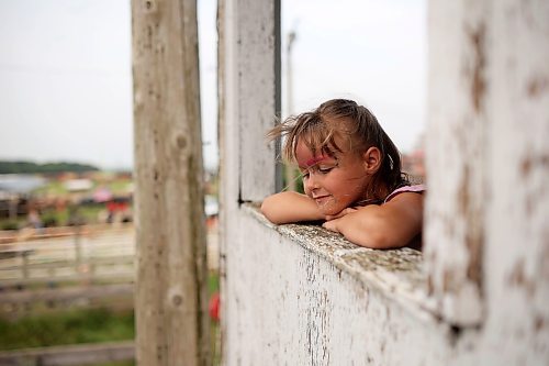 Five-year-old Isabella Lambert looks over the action behind the scenes at the rodeo. (Tim Smith/The Brandon Sun)