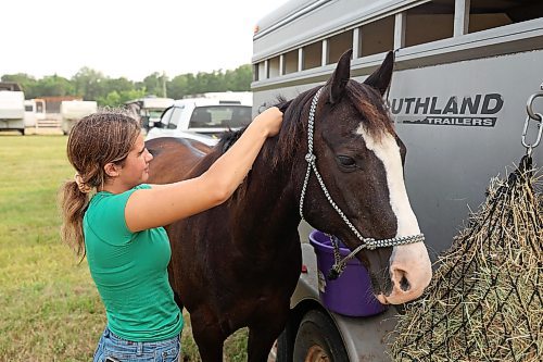 25072024
Sadie Brown of Virden braids the mane of her quarter-horse  Hughy while getting ready to compete in the Jr. Barrels event at the first go-round of the 68th Annual Manitoba Threshermen&#x2019;s Reunion and Stampede rodeo near Austin, Manitoba on Thursday evening.  (Tim Smith/The Brandon Sun)