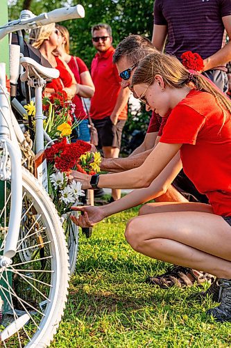 NIC ADAM / FREE PRESS
Hundreds of winnipeggers left flowers at the memorial  ghost bike honouring the life of cyclist Rob Jenner, who lost his life to a hit-and-run driver on Wellington Crescent at Cockburn Street, pictured Thursday afternoon.
240725 - Thursday, July 25, 2024.

Reporter: Jura