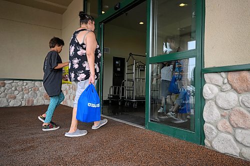 Mike Sudoma/Free Press
Families walk into a hotel where fire evacuees from Marcel Colomb First Nation register to receive aid from Red Cross Friday afternoon
July 26, 2024
