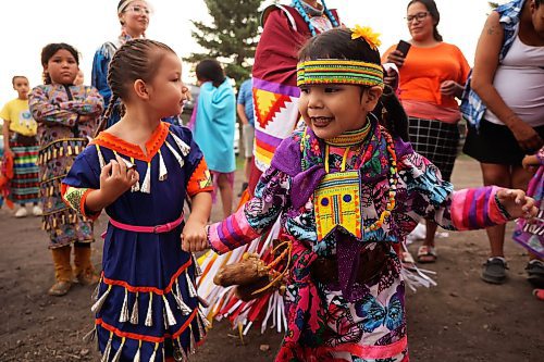 Miika Campbell, 4, and Azrielle Patricio, 3, dance together while waiting to take part in the Grand Entry on the opening night of the Sioux Valley Dakota Nation Pow Wow on Friday evening. (Tim Smith/The Brandon Sun)