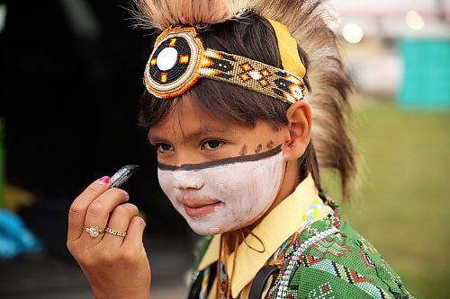 Brody gets a few added touches to his face paint. (Tim Smith/The Brandon Sun)