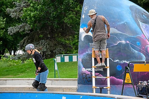 Mike Sudoma/Free Press
Artist Pat Lazo cleans up a plethera of graffiti tags on the mural of Sk8 Skates founder Jai Pereira at the bowl at the Forks Plaza Friday morning
July 26, 2024
