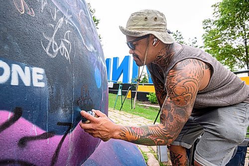 Mike Sudoma/Free Press
Artist Pat Lazo cleans up a plethera of graffiti tags on the mural of Sk8 Skates founder Jai Pereira at the bowl at the Forks Plaza Friday morning
July 26, 2024
