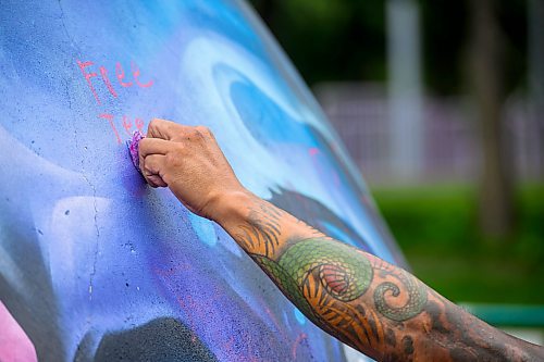 Mike Sudoma/Free Press
Artist Pat Lazo cleans up a plethera of graffiti tags on the mural of Sk8 Skates founder Jai Pereira at the bowl at the Forks Plaza Friday morning
July 26, 2024
