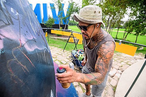 Mike Sudoma/Free Press
Artist Pat Lazo cleans up a plethera of graffiti tags on the mural of Sk8 Skates founder Jai Pereira at the bowl at the Forks Plaza Friday morning
July 26, 2024
