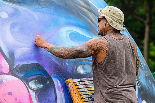 Mike Sudoma/Free Press
Artist Pat Lazo cleans up a plethera of graffiti tags on the mural of Sk8 Skates founder Jai Pereira at the bowl at the Forks Plaza Friday morning
July 26, 2024
