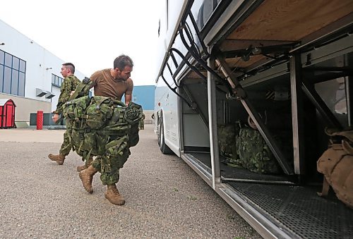 Soldiers with the 2nd Battalion, Princess Patricia's Canadian Light Infantry at CFB Shilo pack up their backpacks and other equipment into a bus for the journey west to Alberta on Friday morning. The company of about 75 troops has been deployed to help battle the raging wildfires in Alberta that most recently destroyed nearly half of the community of Jasper. (Matt Goerzen/The Brandon Sun)