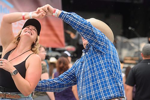 Mike Sudoma/Free Press
(Left to right) Christopher twirls Dana Crane at the Country Rising Music Festival at Blue Cross Park Friday afternoon
July 26, 2024
