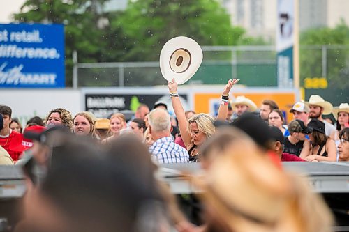 Mike Sudoma/Free Press
An audience member throws their hands and cowboy hat in the year while Jade Eagles opens up the  Country Rising Music Festival at Blue Cross Park Friday afternoon
July 26, 2024
