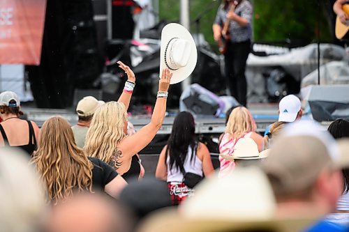 Mike Sudoma/Free Press
An audience member throws their hands and cowboy hat in the year while Jade Eagles opens up the  Country Rising Music Festival at Blue Cross Park Friday afternoon
July 26, 2024
