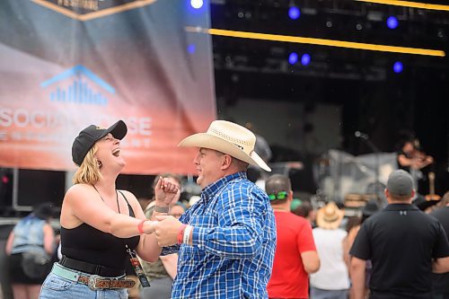 Mike Sudoma/Free Press
(Left to right) Christopher Dana Crane share a moment while dancing to Jade Eagles at the Country Rising Music Festival at Blue Cross Park Friday afternoon
July 26, 2024
