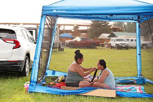 26072024
Miranda Whitequill helps her daughter Miranda Arthurson get ready for Grand Entry on the opening night of the Sioux Valley Dakota Nation Pow Wow on Friday evening. The annual pow wow runs until Sunday and attracts dancers and other visitors from throughout North America. 
(Tim Smith/The Brandon Sun)