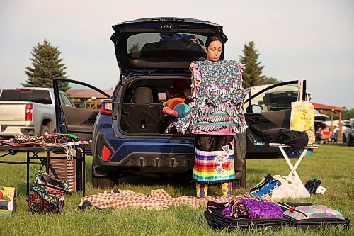 26072024
Mikah Whitecloud of Oklahoma organizes her jingle dresses while getting ready for Grand Entry on the opening night of the Sioux Valley Dakota Nation Pow Wow on Friday evening. The annual pow wow runs until Sunday and attracts dancers and other visitors from throughout North America. 
(Tim Smith/The Brandon Sun)