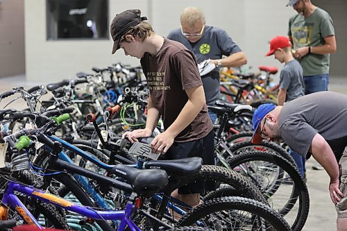 Dorian Parker holds his bidding card as he checks out the bicycles during the Kiwanis Club of Brandon's bike auction on Saturday, held in the Manitoba Room at the Keystone Centre. (Michele McDougall/The Brandon Sun)  