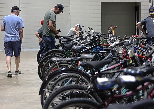 Brad Cormack looks at bicycles for his two sons during the Kiwanis Club of Brandon's bike auction on Saturday, held in the Manitoba Room at the Keystone Centre. (Michele McDougall/The Brandon Sun)  
