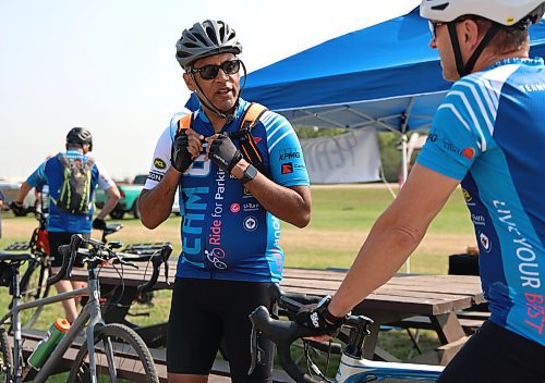 Winnipeg's Tim Hague, the first person with Parkinson’s to run in and win the Amazing Race Canada, and founder of the charity U-Turn Parkinson's takes a breather in Brandon on Sunday. Hague and 13 others are cycling 504 kilometres from Russell to Falcon Lake to raise awareness and money to provide free exercise programs for people living with Parkinson's disease. (Michele McDougall/The Brandon Sun)