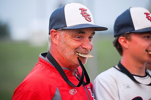 Mike Sudoma/Free Press
Elmwood Giants head coach Dennis Sworyk clenches the first place medal in his mouth during a photo op after his team won the AAA Baseball Manitoba Provincial Championships Sunday evening at Charleswood Place field
July 28, 2024
