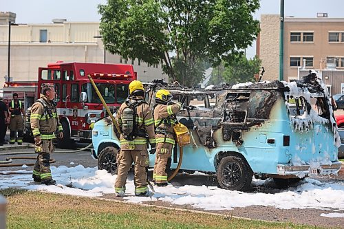 Brandon Fire and Emergency Services firefighters put out the fire inside the GMC camper van in front of the Princess Park Apartments, on Monday afternoon. The fire, which started around 1 pm, severely damaged the camper and partly affected a Dodge caravan parked beside it. Photos: Abiola Odutola/The Brandon Sun