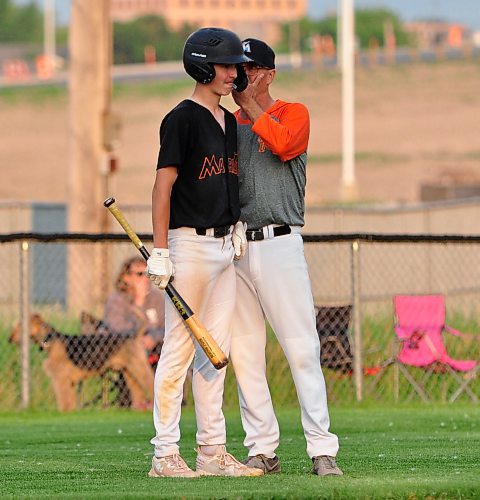 18U AAA Brandon Marlins batter Junior Martine receives advice from head coach and his father Dave Martine during a recent league game at Andrews Field. (Jules Xavier/The Brandon Sun)