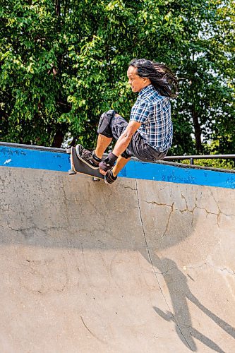 NIC ADAM / FREE PRESS
Multimedia specialist Eric Santiago, 59, shown riding his skateboard at The Forks during his lunch break Monday. He&#x2019;s been riding &#x201c;since forever&#x201d; and says anyone of any age can learn as long as they&#x2019;re determined.
240729 - Monday, July 29, 2024.

Reporter:?