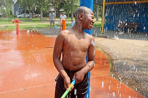 29072024
Victor Aguwa is showered with spray while playing with camp friends at the Stanley Park spray park on a hot Monday afternoon as part of the Manitoba Possible Deaf and Hard of Hearing Day Camp. Participants in the week-long summer camp will also be going bowling, doing pottery, swimming, visiting the Riverbank Discovery Centre and taking part in other activities. 
(Tim Smith/The Brandon Sun)