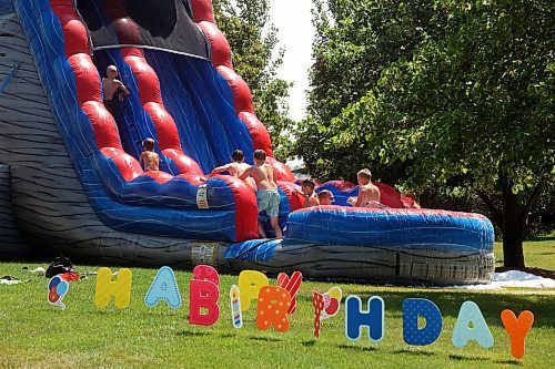 Kids play in water and soap bubbles on the inflatable slide. (Tim Smith/The Brandon Sun)