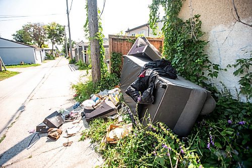 MIKAELA MACKENZIE / FREE PRESS

	
Garbage and furniture behind the scene of a recent fire at a vacant, boarded-up bungalow on Burrows Avenue on Tuesday, July 30, 2024. 

For Nicole story.