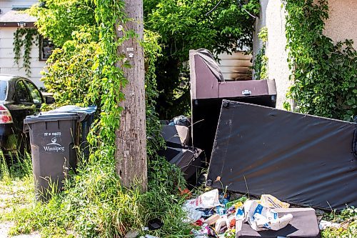 MIKAELA MACKENZIE / FREE PRESS

	
Garbage and furniture behind the scene of a recent fire at a vacant, boarded-up bungalow on Burrows Avenue on Tuesday, July 30, 2024. 

For Nicole story.