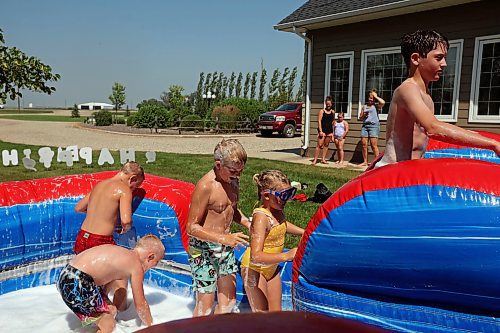 30072024
Kids play in water and soap bubbles on a large inflatable slide during a birthday party for Kord Anderson, twelve, at the Anderson&#x2019;s home east of Souris on a hot Tuesday. (Tim Smith/The Brandon Sun)