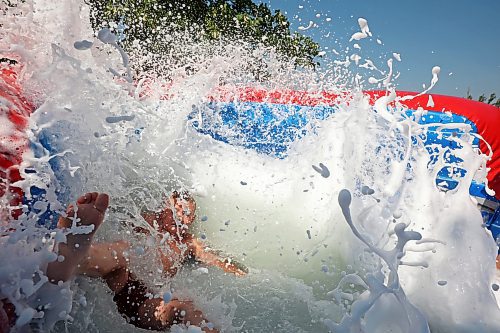 30072024
Dierk Anderson kicks up a big splash of foamy water while beating the heat on Tuesday on a large inflatable slide at the Anderson&#x2019;s home east of Souris during a birthday party for Kord Anderson, who turns twelve today. (Tim Smith/The Brandon Sun)