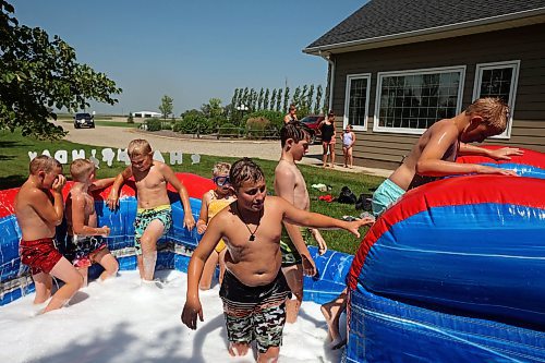 30072024
Kids play in water and soap bubbles on a large inflatable slide during a birthday party for Kord Anderson, twelve, at the Anderson&#x2019;s home east of Souris on a hot Tuesday. (Tim Smith/The Brandon Sun)