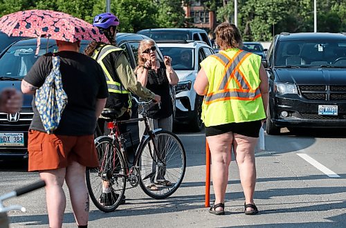 JOHN WOODS / FREE PRESS
A motorist talks to cyclists who blocked cars at the intersection of Academy and Wellington Tuesday, July 30, 2024. Cyclists want safe infrastructure after a child was hit by a driver at the intersection yesterday.

Reporter: ?